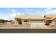 Inviting one-story home with a neutral-colored exterior, desert landscaping, and an attached garage at 3214 W Gilmore Ave, North Las Vegas, NV 89032