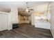 Expansive living area with a fireplace, hardwood floors, open to the kitchen with bright white cabinets at 3214 W Gilmore Ave, North Las Vegas, NV 89032