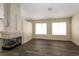 Spacious living room with modern dark wood flooring, a decorative fireplace, and bright natural light at 3214 W Gilmore Ave, North Las Vegas, NV 89032