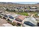 A Primary-planned community featuring modern homes, green spaces, and a playground, set against a mountain backdrop at 3216 Monte Luna Ave, Henderson, NV 89044