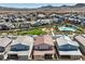 An overview of a community featuring modern homes, a pool, and a playground, all nestled within the desert landscape at 3216 Monte Luna Ave, Henderson, NV 89044