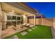 Inviting back patio featuring stylish furniture and well-manicured lawn at 3216 Monte Luna Ave, Henderson, NV 89044