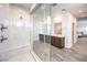 Bright bathroom showcasing a frameless glass shower and dual sinks, complemented by sleek vanities and recessed lighting at 3216 Monte Luna Ave, Henderson, NV 89044