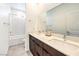 Modern bathroom with double sinks, dark wood cabinets, and a shower-tub combo at 3216 Monte Luna Ave, Henderson, NV 89044