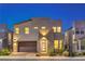Beautiful two-story home at night with attractive exterior lighting and modern architecture at 3216 Monte Luna Ave, Henderson, NV 89044