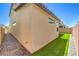Side yard with artificial turf, pavers and gravel against a neutral colored exterior at 3216 Monte Luna Ave, Henderson, NV 89044