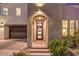 Attractive front entrance at night with stylish lighting, desert landscaping, and an arched covered entry at 3216 Monte Luna Ave, Henderson, NV 89044