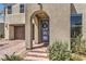 Inviting front entrance with desert landscaping, a brick pathway, and an arched covered entry at 3216 Monte Luna Ave, Henderson, NV 89044