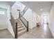 Bright entryway with stairs, a modern bench, tile floors, and natural light at 3216 Monte Luna Ave, Henderson, NV 89044