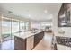 Stylish kitchen features a large central island, modern appliances, and sliding doors to the backyard at 3216 Monte Luna Ave, Henderson, NV 89044