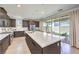 Contemporary kitchen boasts an oversized island, sleek cabinetry, and outdoor access to the patio at 3216 Monte Luna Ave, Henderson, NV 89044
