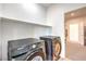 Laundry area features front loading washer and dryer, storage shelf, and adjacent closet at 3216 Monte Luna Ave, Henderson, NV 89044
