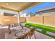 Relaxing covered patio with comfortable seating and artificial grass at 3216 Monte Luna Ave, Henderson, NV 89044