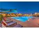 Night view of a luxurious community pool with ample seating and modern design at 3216 Monte Luna Ave, Henderson, NV 89044