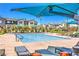 Community pool area with sunshades and lounge seating, surrounded by modern architecture at 3216 Monte Luna Ave, Henderson, NV 89044
