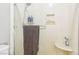 Modern shower with a rainfall showerhead, built-in shelving, and sleek glass door at 3233 Kinsale Ct, Las Vegas, NV 89121