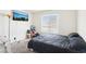 Neutral bedroom featuring a comfortable bed, a large window, and a TV at 3233 Kinsale Ct, Las Vegas, NV 89121