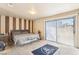 Spacious bedroom with carpet, slider doors, and a neutral color palette at 3233 Kinsale Ct, Las Vegas, NV 89121