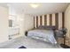 Bedroom showcasing a striped accent wall and an adjoining bathroom at 3233 Kinsale Ct, Las Vegas, NV 89121
