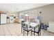 Bright kitchen with tile flooring, white appliances, and a sliding glass door to the outdoor area at 3233 Kinsale Ct, Las Vegas, NV 89121