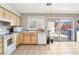 Open kitchen with light wood cabinetry, tile floors, and access to the outdoor patio at 3233 Kinsale Ct, Las Vegas, NV 89121