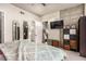 Bright bedroom features concrete accent wall, decorative mirror, TV, and neutral color scheme at 353 E Bonneville Ave # 632, Las Vegas, NV 89101
