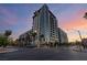 An eye-level exterior shot of a high-rise apartment building, featuring palm trees and street lights at 353 E Bonneville Ave # 632, Las Vegas, NV 89101