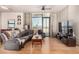 Living room featuring hardwood floors, a large window, and concrete walls at 353 E Bonneville Ave # 632, Las Vegas, NV 89101