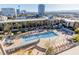 Aerial view of a pool with palm trees and cityscape views at 353 E Bonneville Ave # 632, Las Vegas, NV 89101