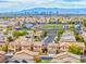 High angle shows a neighborhood, school, and city in the distance at 3696 Via Geneva, Henderson, NV 89052