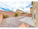 Spacious, low-maintenance backyard featuring rock landscaping and privacy wall at 3696 Via Geneva, Henderson, NV 89052