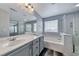 Bathroom with dual vanity, tub and glass enclosed shower offers spa-like experience at 3696 Via Geneva, Henderson, NV 89052