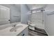 Bright bathroom featuring a marble vanity top, bathtub, shower, and modern fixtures at 3696 Via Geneva, Henderson, NV 89052