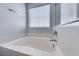 Close up of soaking tub with marble surround and modern fixtures at 3696 Via Geneva, Henderson, NV 89052