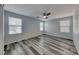 Spacious bedroom featuring modern ceiling fan, wood-look flooring and bright natural light at 3696 Via Geneva, Henderson, NV 89052