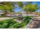 Community pool with sculpture, well maintained landscaping, and trees at 3696 Via Geneva, Henderson, NV 89052