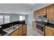 Bright kitchen featuring granite countertops, stainless steel appliances, light wood cabinets, and an open layout at 3696 Via Geneva, Henderson, NV 89052