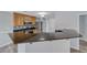 Bright kitchen featuring granite countertops, stainless steel appliances, light wood cabinets, and an eat in counter at 3696 Via Geneva, Henderson, NV 89052