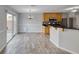 Open concept kitchen features granite countertops, wood cabinets, stainless appliances, and sliding door access to patio at 3696 Via Geneva, Henderson, NV 89052