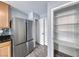 Bright kitchen featuring stainless steel appliances, light wood cabinets and a pantry at 3696 Via Geneva, Henderson, NV 89052