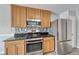 Bright kitchen featuring granite countertops, stainless steel appliances and light wood cabinets at 3696 Via Geneva, Henderson, NV 89052