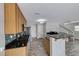 Bright kitchen features stainless appliances, granite countertops, and open layout to the living spaces at 3696 Via Geneva, Henderson, NV 89052