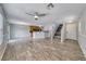 Spacious living room features wood-look floors, modern lighting, and easy access to the kitchen and entry at 3696 Via Geneva, Henderson, NV 89052