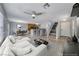 Bright, open-concept living area with a ceiling fan and combined kitchen and dining areas at 3696 Via Geneva, Henderson, NV 89052