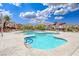 Community pool featuring a clear swimming area, blue accents, lounge chairs, and nearby residential buildings at 3696 Via Geneva, Henderson, NV 89052