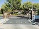 Community gate with iron bars and mature landscaping to keep the property secure at 4567 Madreperla St, Las Vegas, NV 89121