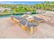 Aerial view of an unfinished, modern home with dark roofing near a small lake at 54 Bellissima Lago Ct, Henderson, NV 89011