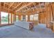Interior framing during new home construction with supplies, showcasing future layout with natural light at 54 Bellissima Lago Ct, Henderson, NV 89011