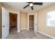 Carpeted bedroom with ceiling fan, neutral walls, and multiple doors at 5676 Bettors Luck Ct, Las Vegas, NV 89122