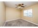 Bedroom featuring a window and a modern ceiling fan at 5676 Bettors Luck Ct, Las Vegas, NV 89122